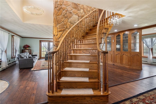 stairs with recessed lighting, ornamental molding, a notable chandelier, and hardwood / wood-style floors