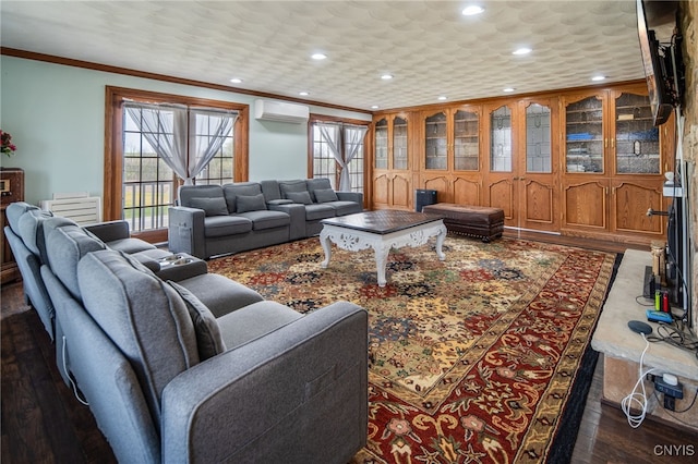 living room with plenty of natural light, ornamental molding, a wall unit AC, and recessed lighting