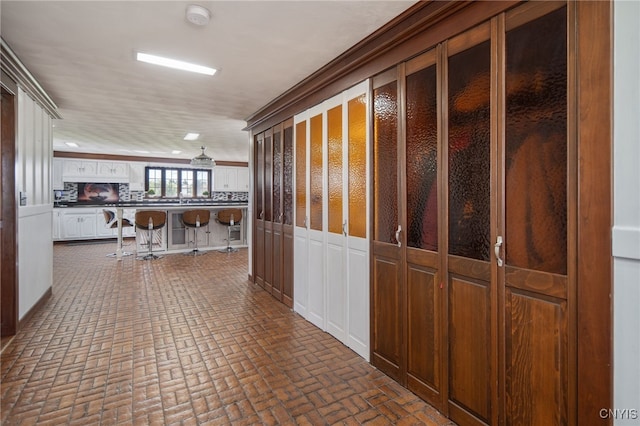 hallway with brick floor