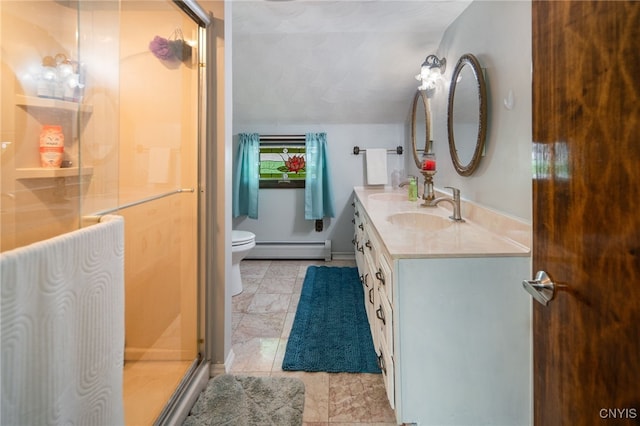 full bath featuring a sink, double vanity, toilet, a baseboard heating unit, and a stall shower