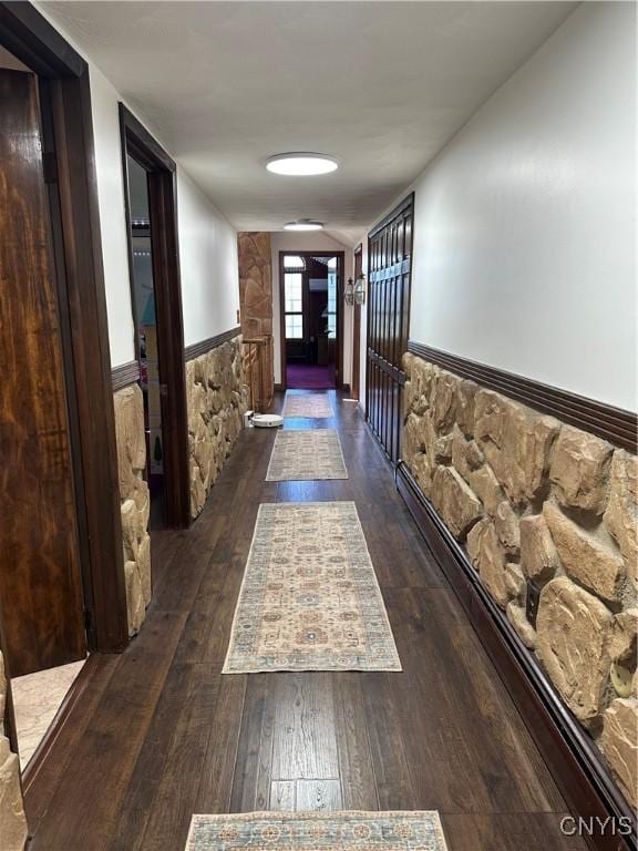 hallway featuring wainscoting and hardwood / wood-style floors