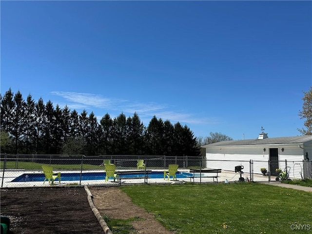 view of pool with a lawn, fence, and a fenced in pool