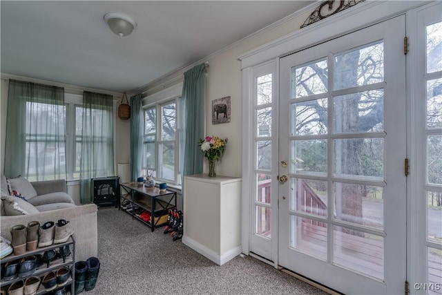 interior space with crown molding, carpet, and baseboards