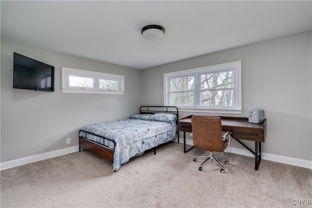 bedroom featuring baseboards and carpet