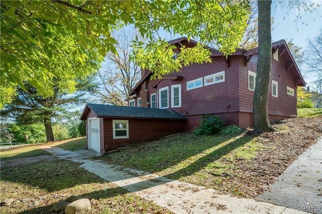 view of property exterior featuring an outbuilding