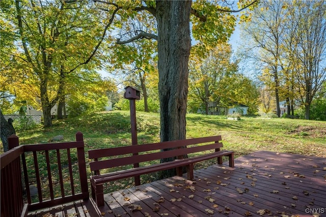 wooden terrace featuring a yard