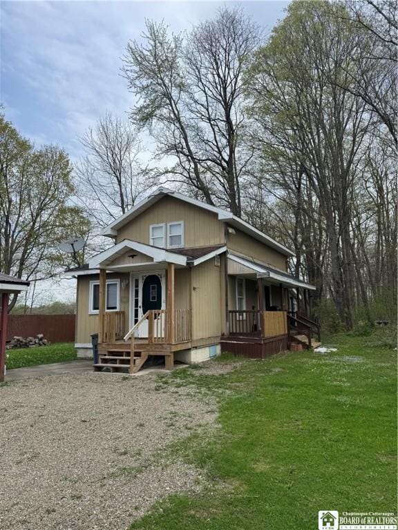 view of front of home with covered porch and a front yard