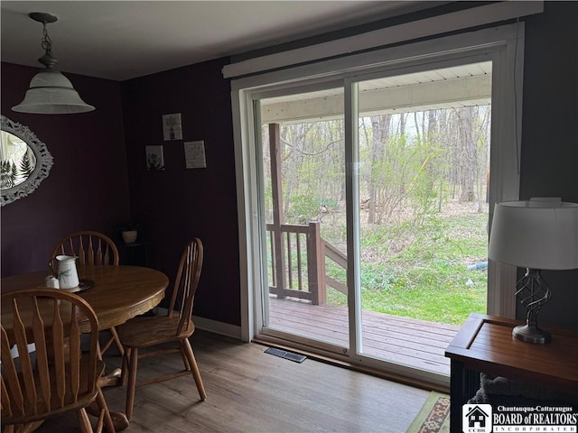 dining room with visible vents, baseboards, and wood finished floors