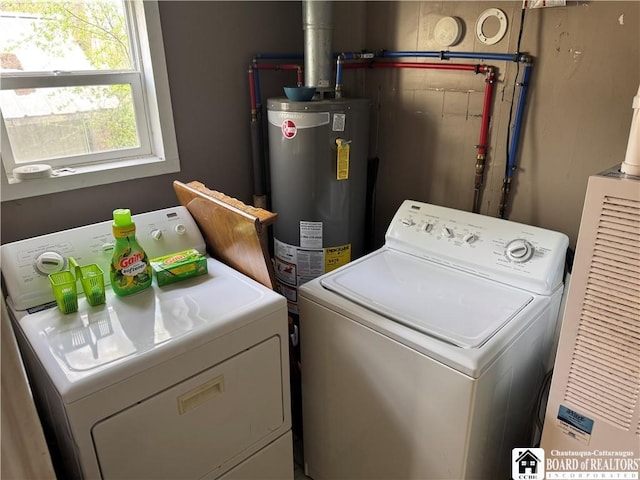 washroom with gas water heater, laundry area, and washing machine and dryer