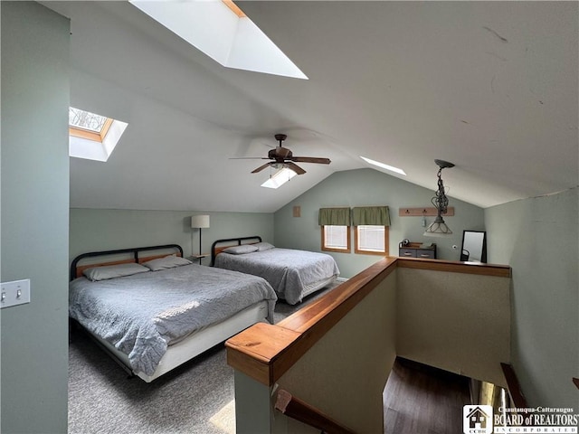 bedroom featuring vaulted ceiling with skylight, ceiling fan, and dark wood-style floors