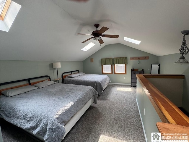 carpeted bedroom featuring a ceiling fan and vaulted ceiling with skylight