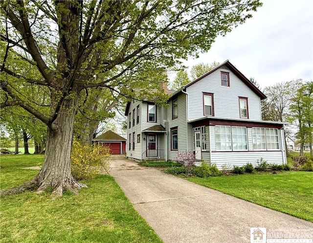 traditional home with an outdoor structure, a front lawn, a sunroom, and a chimney