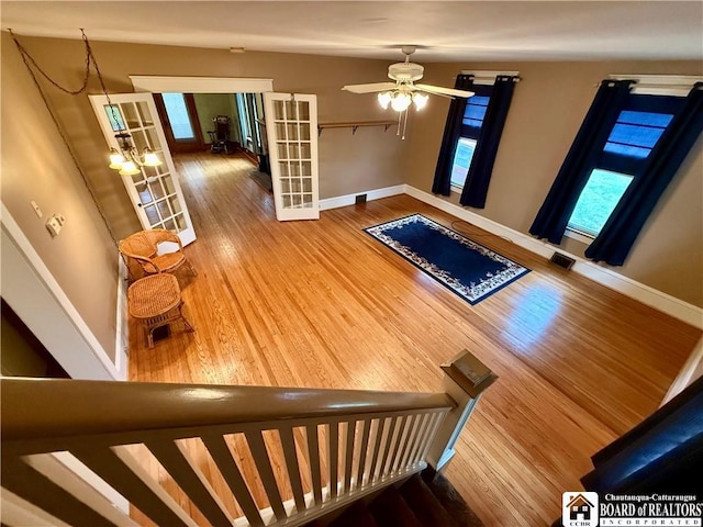 foyer with french doors, baseboards, visible vents, and wood finished floors
