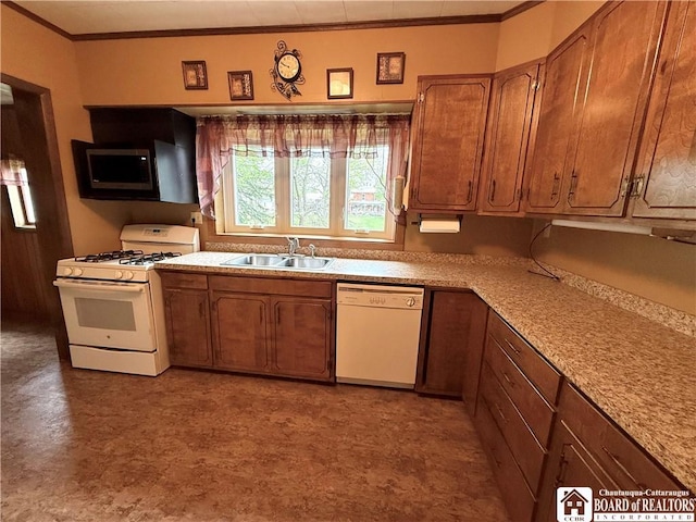 kitchen with a sink, white appliances, light countertops, brown cabinetry, and ornamental molding