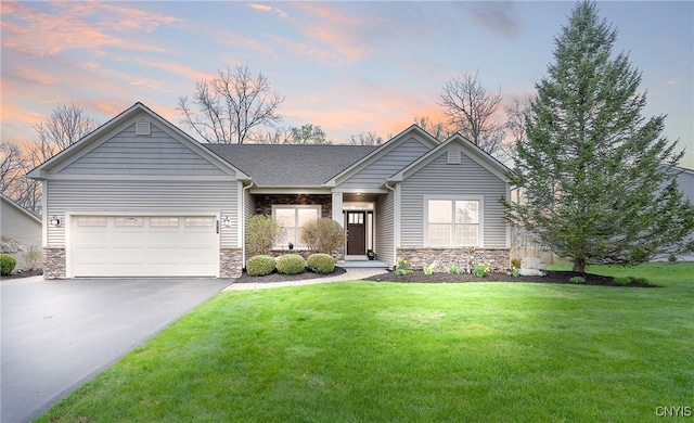 view of front of house with a garage, a yard, aphalt driveway, and stone siding
