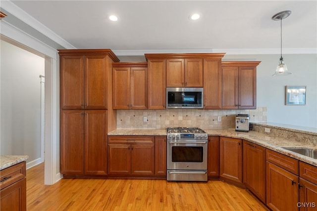 kitchen featuring brown cabinets, stainless steel appliances, decorative backsplash, and light wood-type flooring