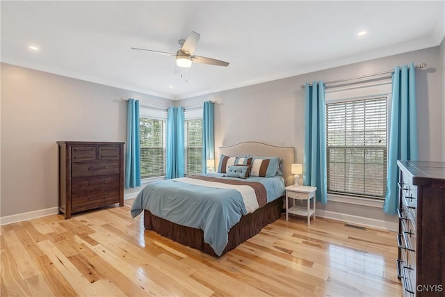 bedroom with crown molding, recessed lighting, baseboards, and light wood-style floors