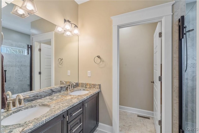 bathroom with visible vents, a sink, a tile shower, and double vanity