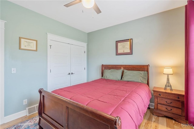 bedroom with a ceiling fan, baseboards, light wood-type flooring, visible vents, and a closet