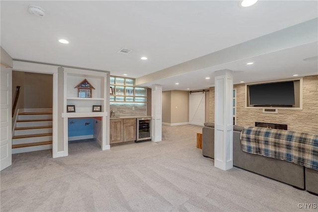 living area with light colored carpet, stairway, baseboards, wine cooler, and bar area