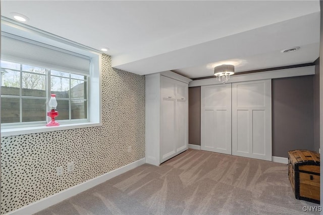 unfurnished bedroom with light colored carpet, recessed lighting, baseboards, and visible vents