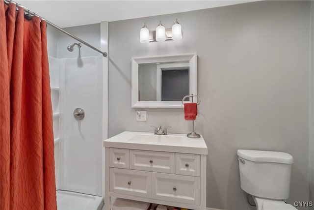 full bathroom with vanity, a shower with shower curtain, and toilet