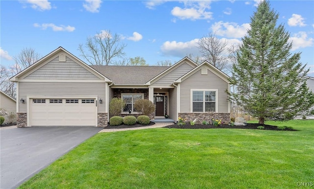 view of front of house featuring an attached garage, a front yard, driveway, and stone siding