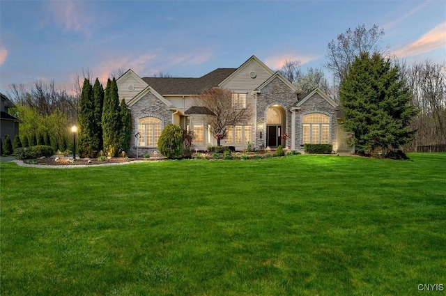 view of front facade with a front lawn and stone siding