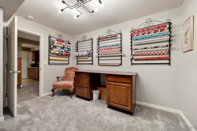 sitting room featuring baseboards and light carpet