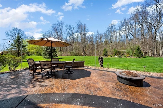 view of patio with outdoor dining space and an outdoor fire pit