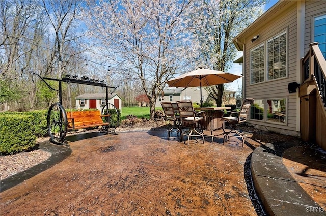 view of yard featuring a storage shed, a patio, an outdoor structure, and outdoor dining space