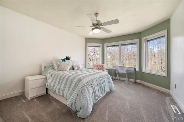 carpeted bedroom with baseboards, visible vents, and ceiling fan