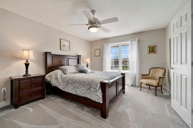 bedroom with baseboards, a ceiling fan, and light colored carpet
