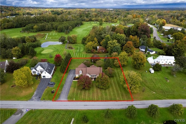 drone / aerial view with a water view and golf course view