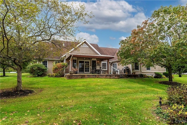 back of house featuring a lawn and a porch