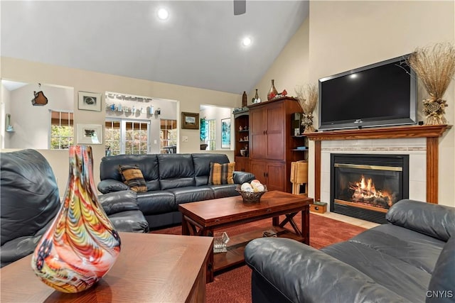 living room featuring recessed lighting, high vaulted ceiling, and a tile fireplace