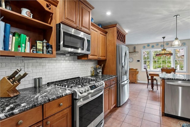 kitchen featuring backsplash, appliances with stainless steel finishes, open shelves, brown cabinets, and baseboards
