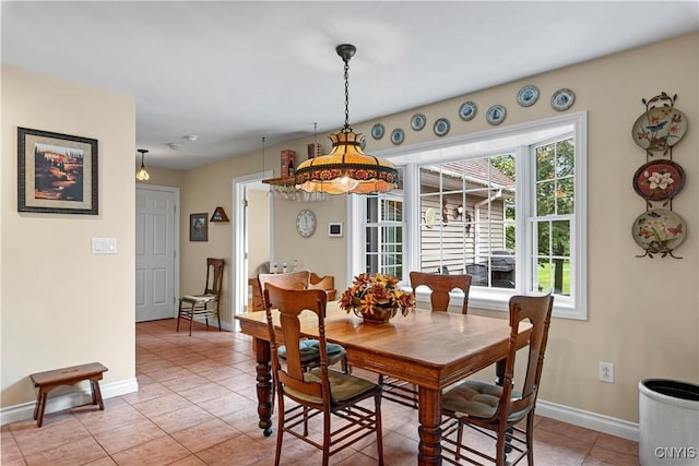 dining area with baseboards and light tile patterned floors