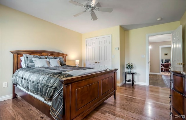bedroom featuring baseboards, ceiling fan, and wood finished floors