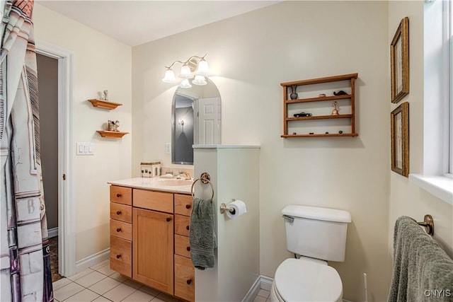 half bath featuring toilet, tile patterned flooring, and vanity