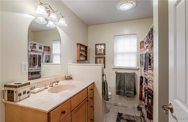 bathroom featuring toilet, tile patterned floors, and vanity