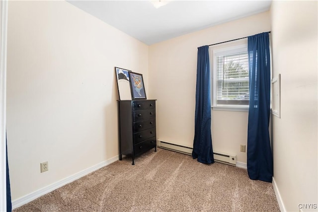 empty room featuring carpet flooring, baseboards, and baseboard heating