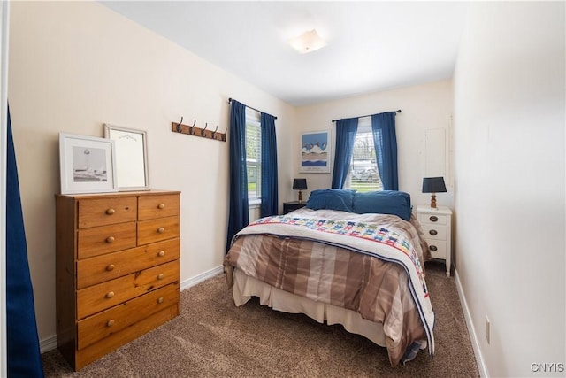 bedroom featuring baseboards and carpet