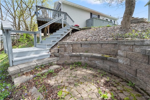 view of property exterior with a wooden deck and stairs