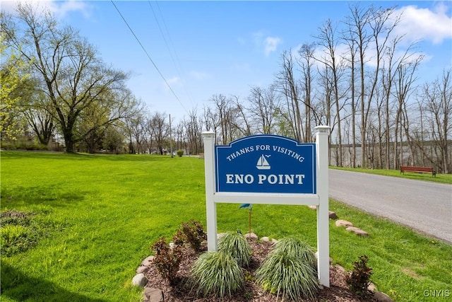 community sign featuring a lawn