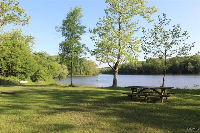 exterior space featuring a water view and a wooded view
