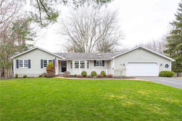 single story home featuring an attached garage, driveway, and a front lawn