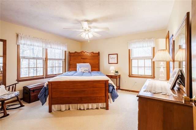 carpeted bedroom with baseboards and ceiling fan