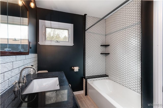 bathroom featuring baseboards and a sink