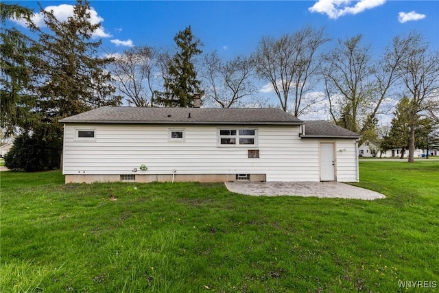 rear view of property with a lawn and a patio